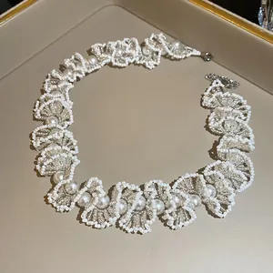 Elegant French style beaded pearl necklace close-up on a luxury beige jewelry tray