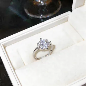Detailed view of an elegant marquise-cut zircon ring in a white velvet gift box