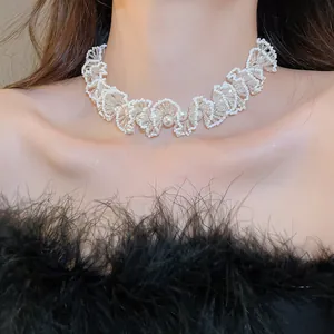 Close-up of an elegant French style ruffled pearl beaded choker on neck.