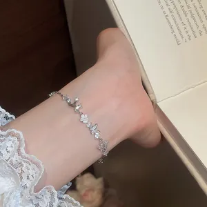 Detailed close-up of elegant zircon butterfly anklet with shimmering mother-of-pearl accents