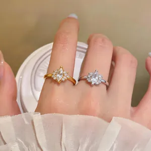 Detailed macro view of elegant marquise-cut zircon rings in gold and silver finishes