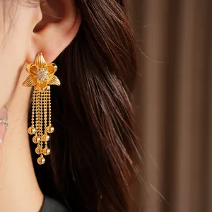 Detail of 18k gold plated flower tassel earrings with sparkling zircon inlay
