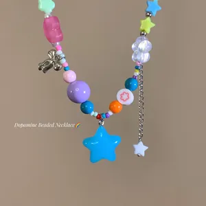 Close-up of colorful dopamine beaded necklace with star pendant and candy beads.