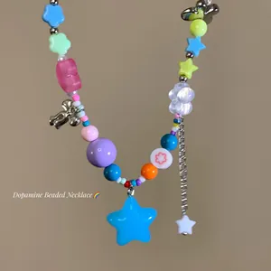 Macro detail of colorful dopamine beaded necklace with a bright blue star pendant