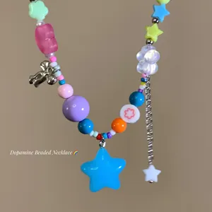Macro view of colorful dopamine candy star beaded necklace with metallic chain