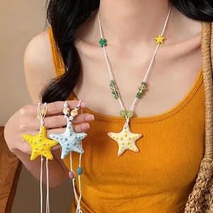 Detailed view of colorful ceramic starfish necklaces for beach vacation outfits.