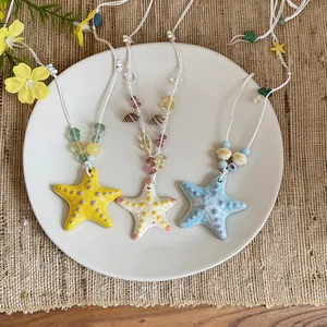 Handmade ceramic starfish necklaces in vibrant colors for beach vacation styling