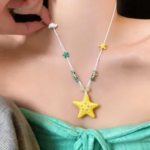 Close-up of a colorful ceramic starfish necklace for seaside vacation style