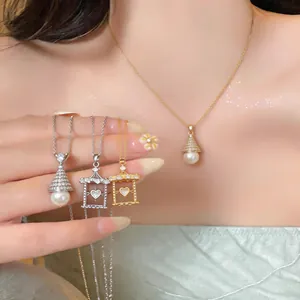 Close-up detail of luxury zircon fan-shaped and heart frame pearl necklaces on skin