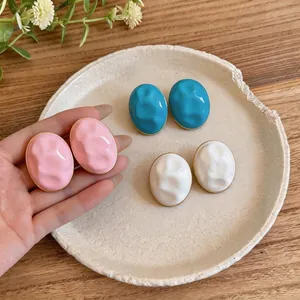 Oval acrylic textured stud earrings in macaron colors with gold-tone edge design