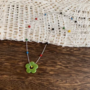 Summer dopamine style colorful beaded necklace featuring a vibrant green flower pendant