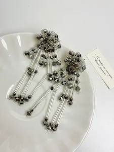 Detailed close-up of elegant palace style flower tassel earrings with shimmering beads
