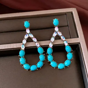 Vintage teardrop earrings with blue turquoise stones and iridescent rhinestones.