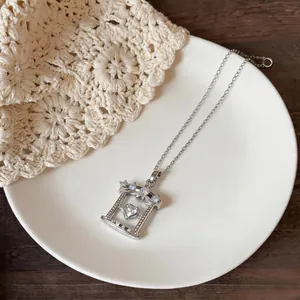 Detailed shot of a silver necklace featuring a heart-shaped zircon within a framed pendant.