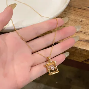 Detailed view of a gold necklace featuring a unique heart zircon swing pendant design.