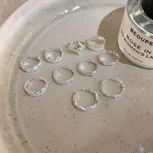 Elegant French lace and star silver rings set displayed on a minimalist ceramic plate