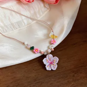 Summer vacation style beaded necklace with resin flower pendant and stone accents