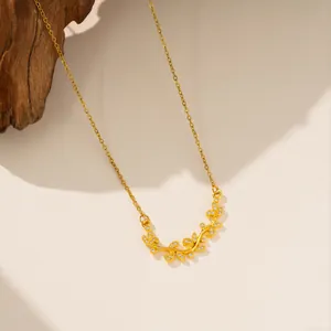 Vista detallada del colgante de hoja dorada con circonitas en una cadena delicada