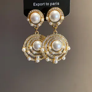 Detaillierte Nahaufnahme von Vintage-Strass- und Perlen-Hängeohrringen für Damen