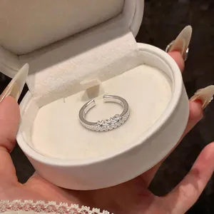 Close-up of a French style double-layered silver ring with stars and stones in a gift box