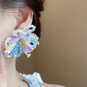 Detailed close-up of vibrant multicolored beaded flower earrings for a summer holiday look