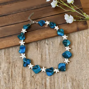 Close-up detail of blue and white starfish beads on a beach vacation style necklace
