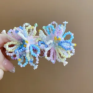 Vibrant colorful beaded flower earrings in summer dopamine style detail close-up view