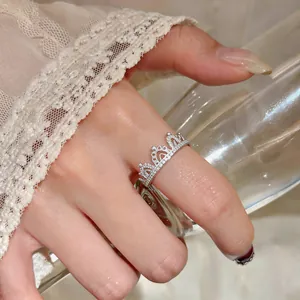 Macro detail of an elegant silver crown-shaped ring adorned with sparkling clear stones