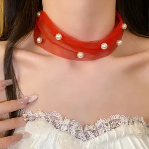 Detailed view of sweet red mesh choker necklace decorated with elegant pearls on neck