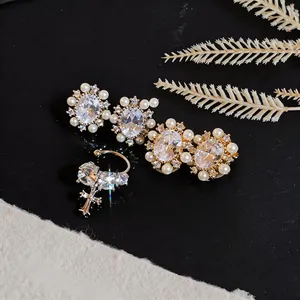 Detailed view of luxury 14k gold plated clip-on earrings with shimmering zircons and pearls