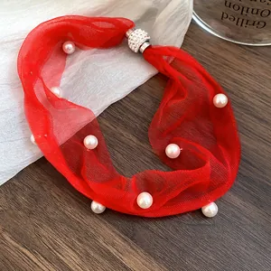 Detailed view of vacation style red mesh necklace with pearls and crystal magnetic clasp