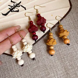 Detailed view of vintage Chinese style wooden lotus flower earrings in multiple colors.