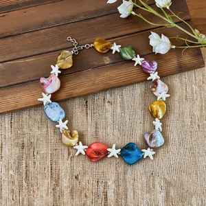 Detailed view of colorful shell and starfish beaded necklace for beach vacations.