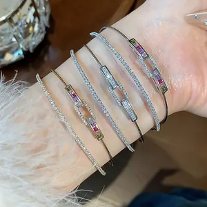 Detailed view of 18k gold plated double-layer zircon bracelets with colorful stones on a wrist.