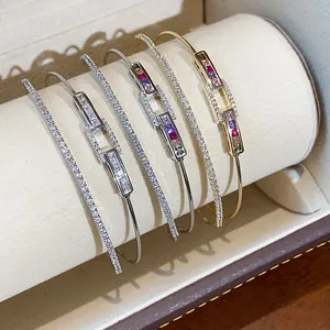 Close-up of four 18k gold plated zircon double-layer rectangular luxury bangles