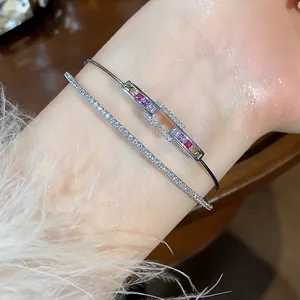 Macro shot of silver-tone double-layer bracelet featuring rainbow and white cubic zirconia