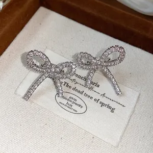 Sparkling silver bow-knot ear clips with premium zircons for non-pierced ears