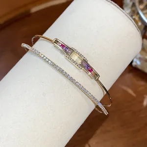 Detail of 18k gold plated bracelet with colorful rectangle stones and pavé cubic zirconia.