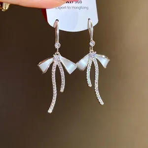 Elegant French style bowknot drop earrings with sparkling zircons and white enamel finish.