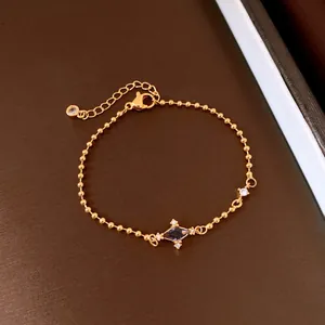 Detail view of a vintage gold bracelet with starburst charm and cubic zirconia stones