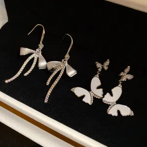 Close-up of French style zircon enamel bow and butterfly earrings in a jewelry box