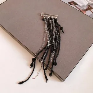 Elegant vintage safety pin brooch with long black beaded tassels and silver chains