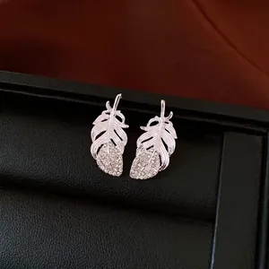Vintage silver feather stud earrings with sparkling rhinestones, elegant minimalist jewelry.
