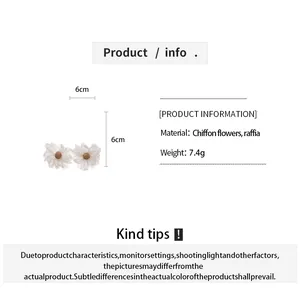Detail view of handmade chiffon flower and raffia earrings with dimensions and weight info