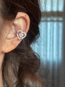 Detailed view of a silver heart-shaped zircon ear cuff featuring a sparkling star motif
