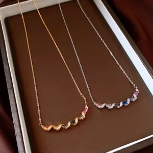 Close-up of elegant gold and silver twisted necklaces with colorful oval gemstones