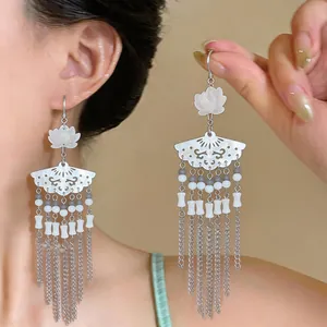 Detail of elegant lotus fan earrings with long silver tassels in Chinese style