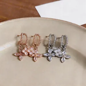 Elegant French style flower stud earrings with sparkling cubic zirconia in rose gold and silver