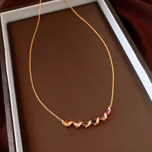 Detailed macro view of a gold twist collar necklace set with vibrant multi-colored gemstones