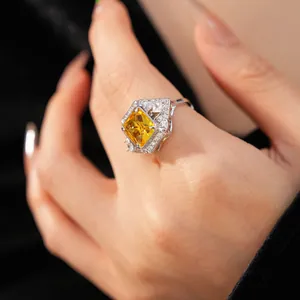 Close-up detail of geometric square yellow zircon ring with palace style setting